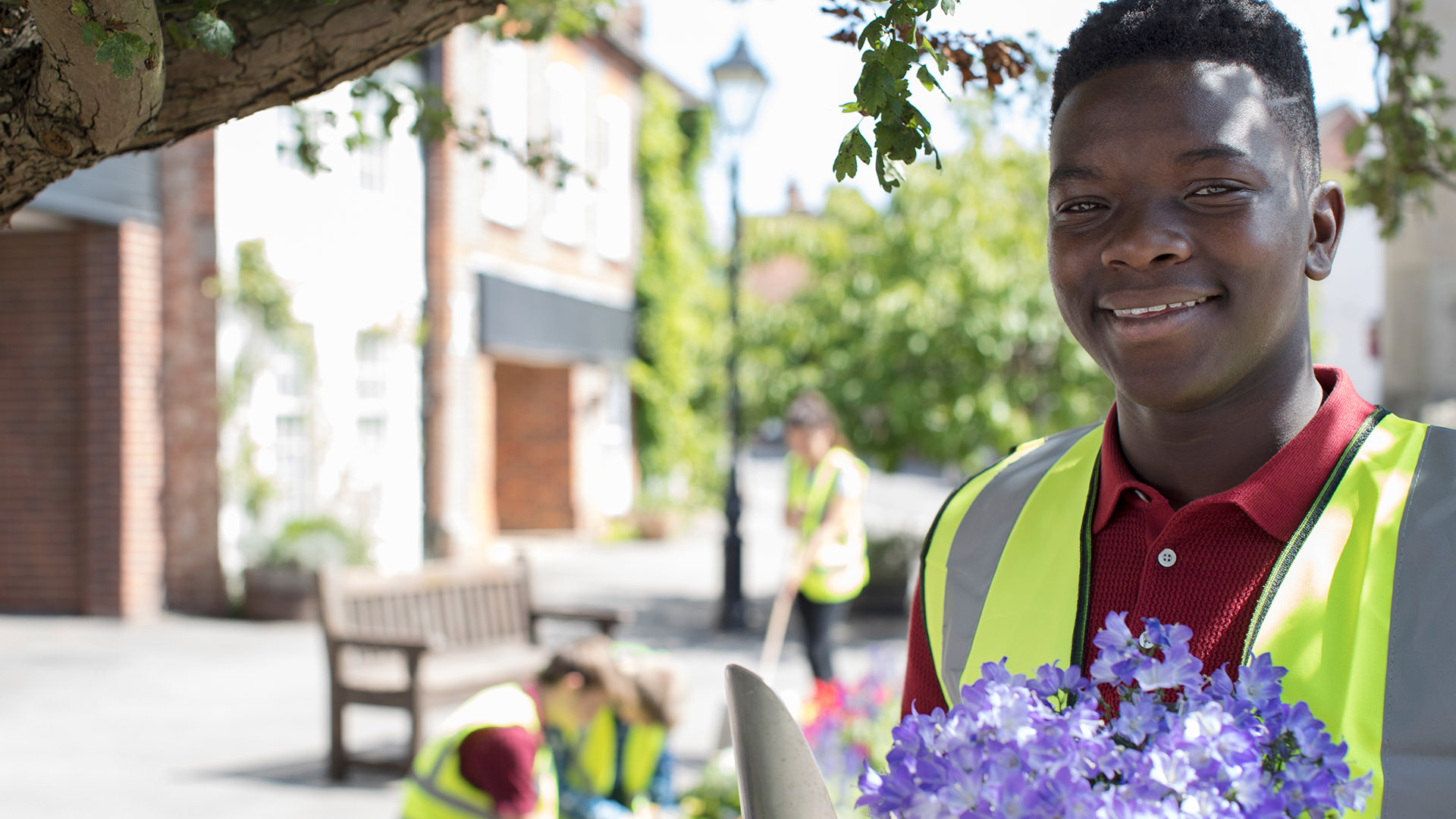 Young man volunteering to help the community garden