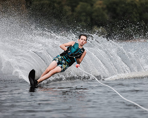 Noah water skiing on the lake