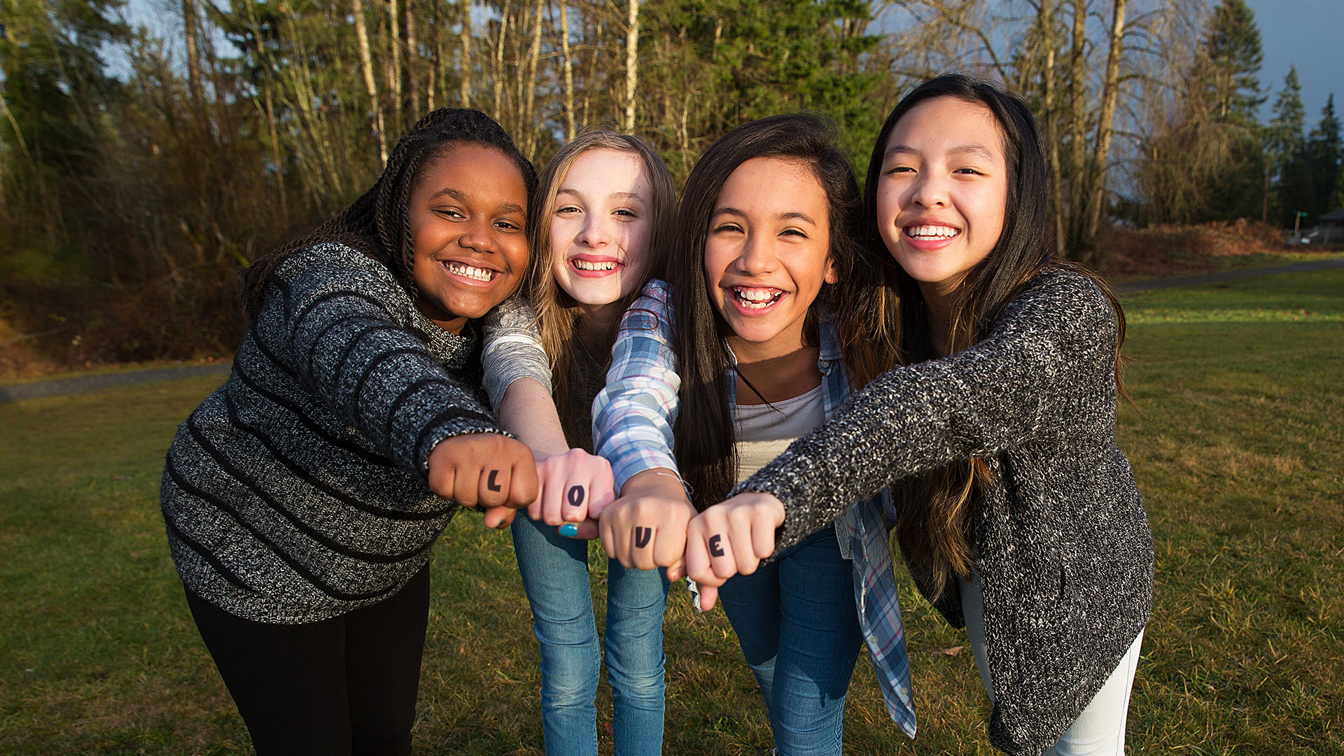 Teen girls with the word LOVE written on their hands