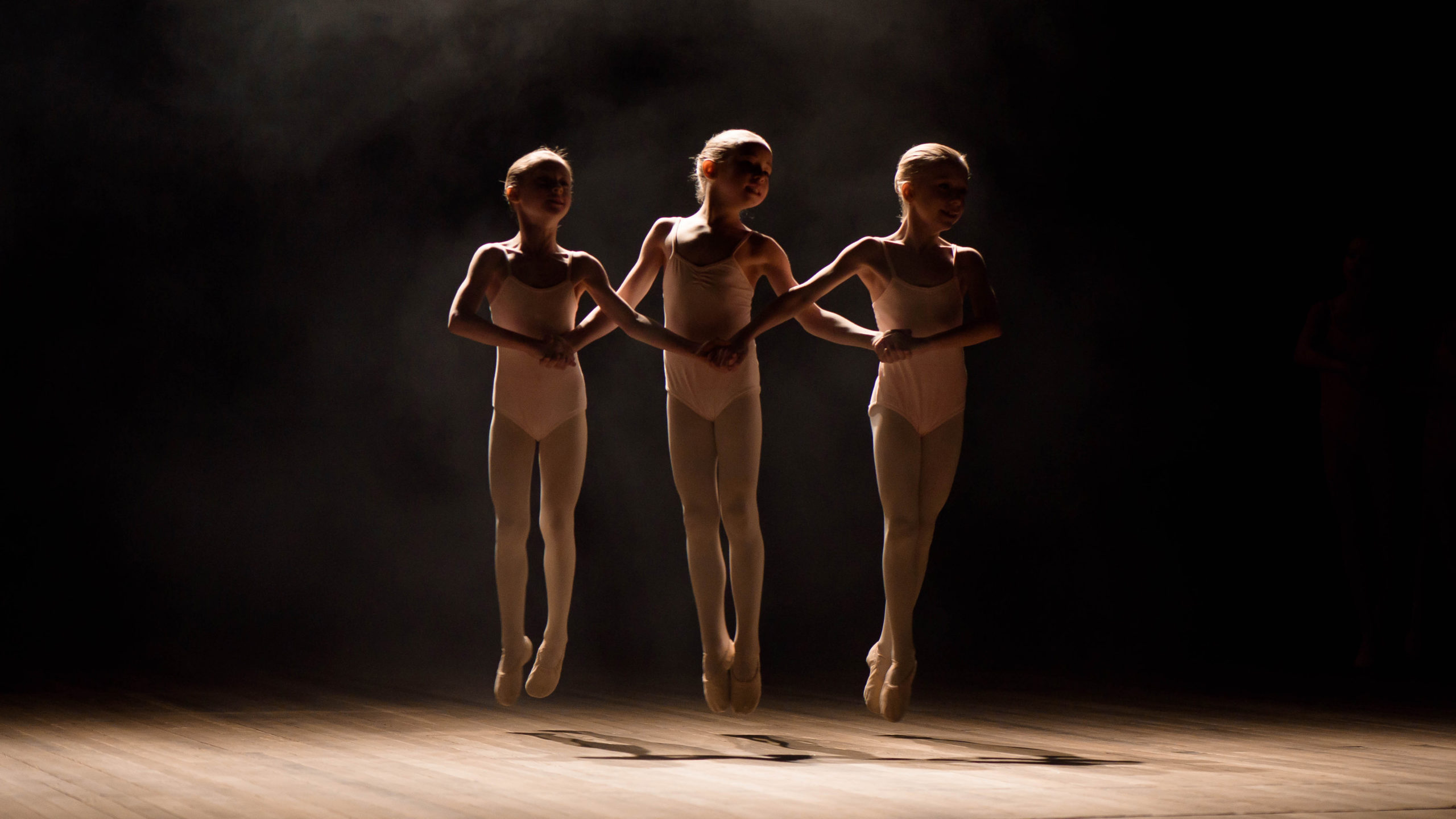 happy children doing ballet jump